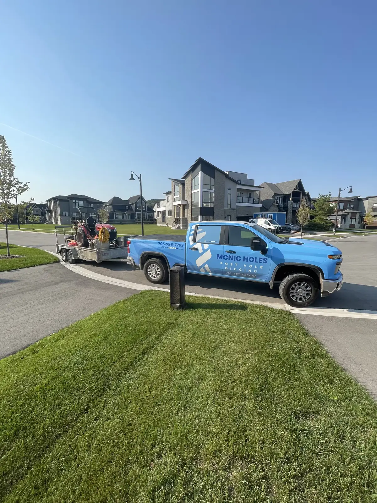 McNic Holes post hole digging truck parked on a residential street